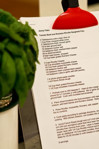 Jenny's Spaghetti Pies Recipe on a Clipboard Next to a Potted Plant