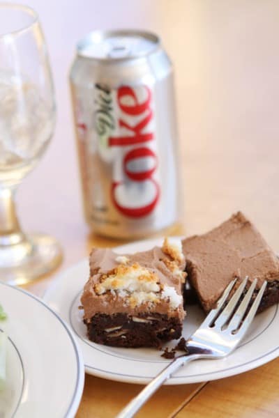 Two Brownies on a Small White Dessert Plate with a Fork