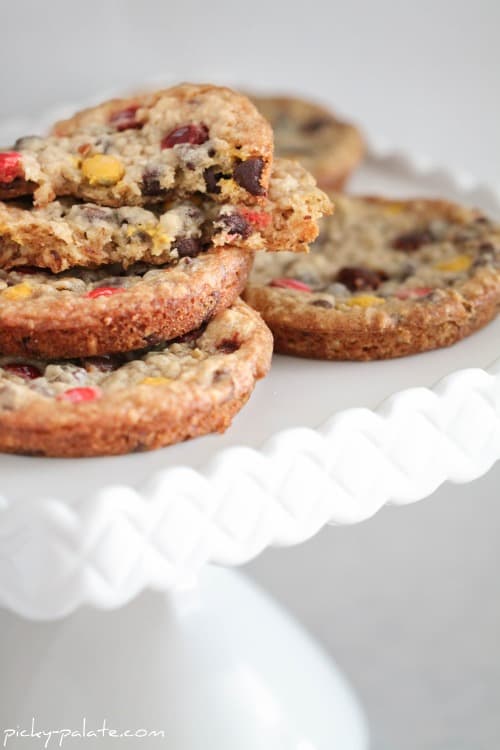 A stack of Butterscotch Oatmeal M&M cookies on a white platter