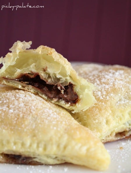 Close up of a triangular turnovers filled with nutella and marshmallow.