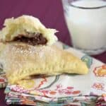 Triangular turnovers filled with nutella and marshmallow on a cloth napkin