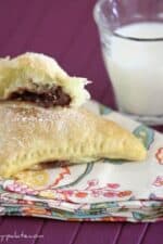 Triangular turnovers filled with nutella and marshmallow on a cloth napkin