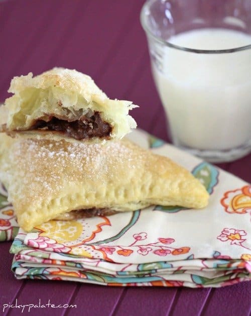 Triangular turnovers filled with nutella and marshmallow on a cloth napkin