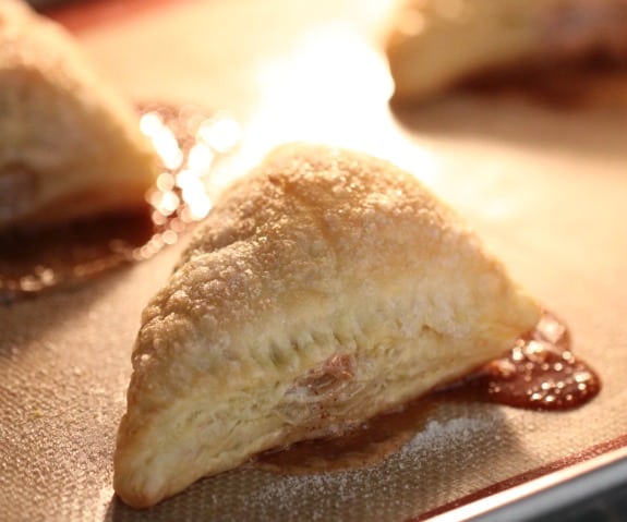 Nutella marshmallow turnovers baking in the oven.