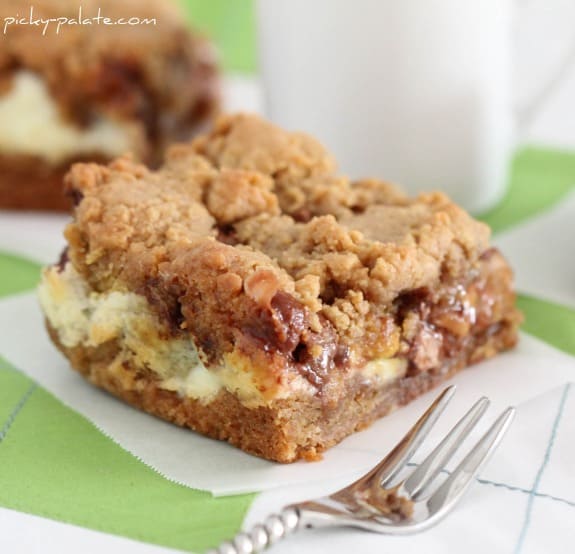 A cream cheese peanut butter cookie bar next to a fork.