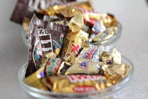 Assorted wrapped Halloween candy in a glass dish.