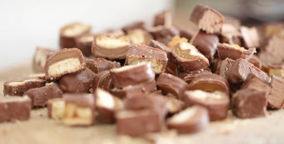 Chopped chocolate candy bars on a cutting board.