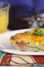 A wedge of Ham and Cheddar Fritatta on a plate