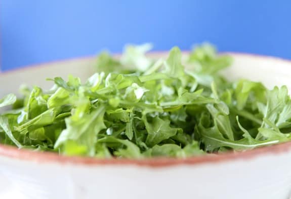 Arugula leaves in a bowl.