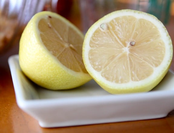 Two halves of a lemon on a plate.