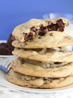 brownie stuffed chocolate chip cookies stacked on serving plate