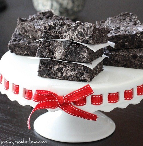 Photo shows pieces of cookies and cream bars on a white cake stand