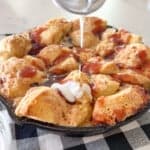 drizzling icing over easy monkey bread recipe