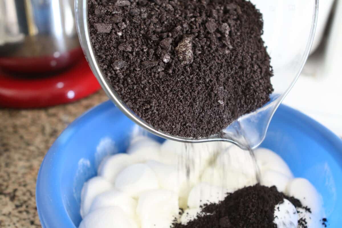 pouring ground Oreos into melted marshmallows
