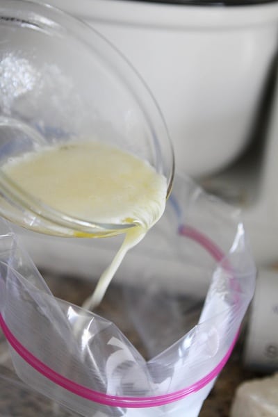 Pouring melted butter into a large Ziploc bag
