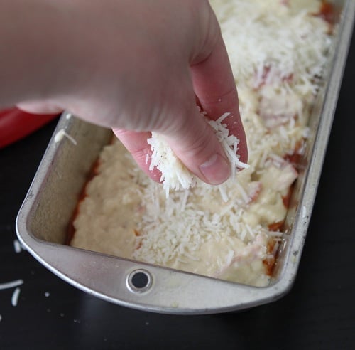 Sprinkling Parmesan on Top of Pepperoni Pizza Quick Bread