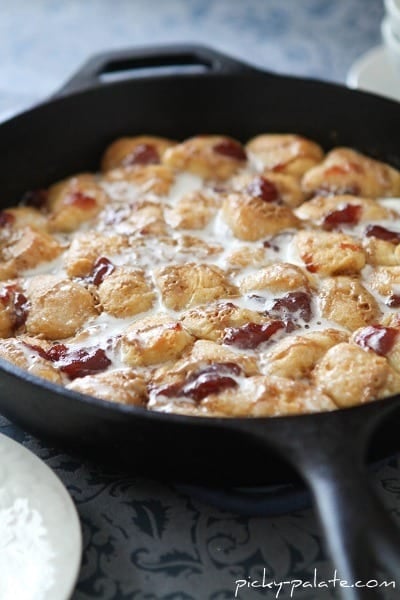 Peanut butter and jelly monkey bread in a cast iron skillet.