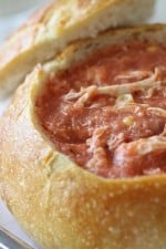 Close-up of Creamy Tomato Soup with Corn, Chicken and Bacon in a Bread Bowl