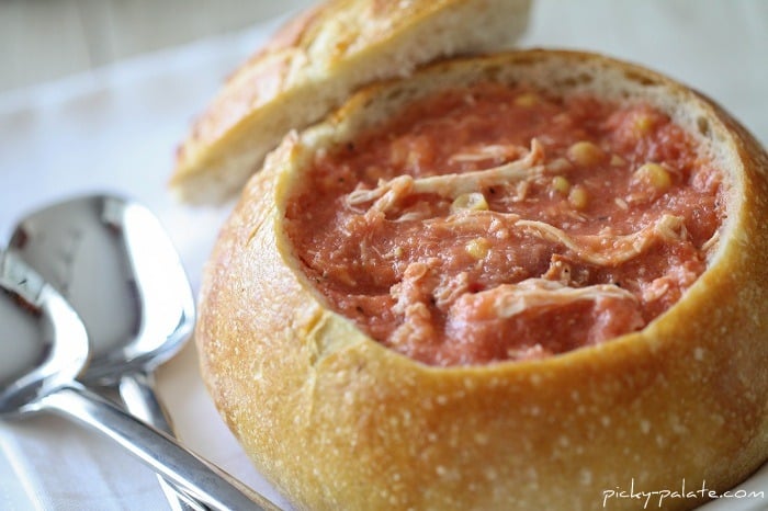 Close-up of Creamy Tomato Soup with Corn, Chicken and Bacon in a Bread Bowl