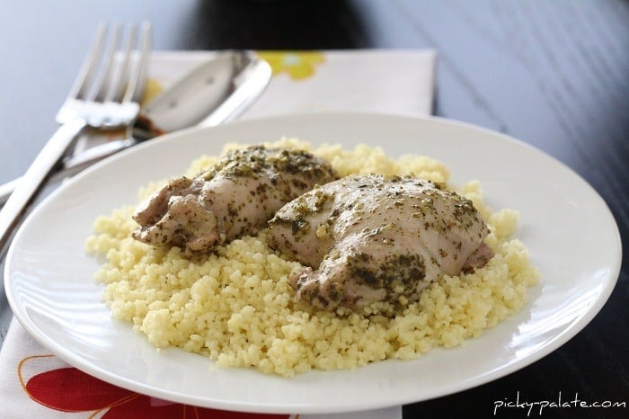 Pesto Chicken Thighs with Italian Creme Sauce Over Parmesan Couscous on a Plate