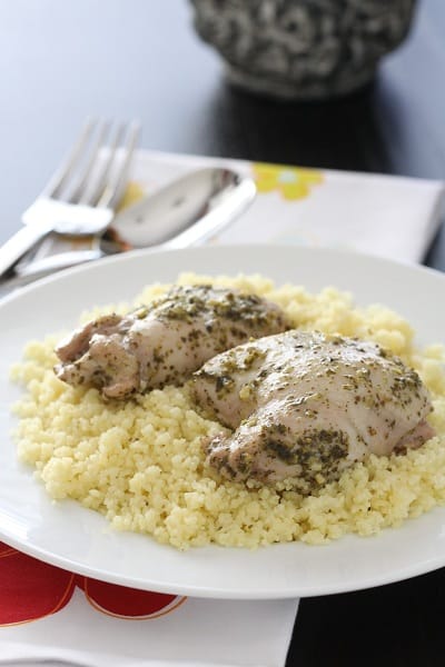 A Serving of Pesto Chicken Thighs with Italian Creme Sauce Over Parmesan Couscous