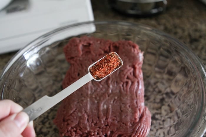 Image of Adding Seasoning to the Bowl with the Beef 