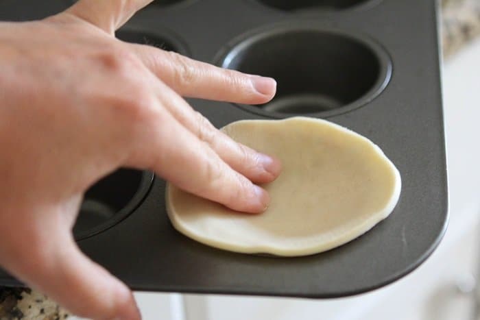 Image of Putting Pie Dough Into the Muffin Pan