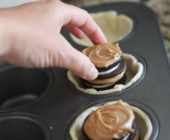 Image of Placing Oreos and Peanut Butter Into Pies