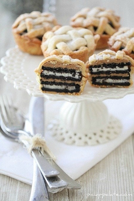 Image of Peanut Butter Oreo Lattice Pies on a Cake Stand