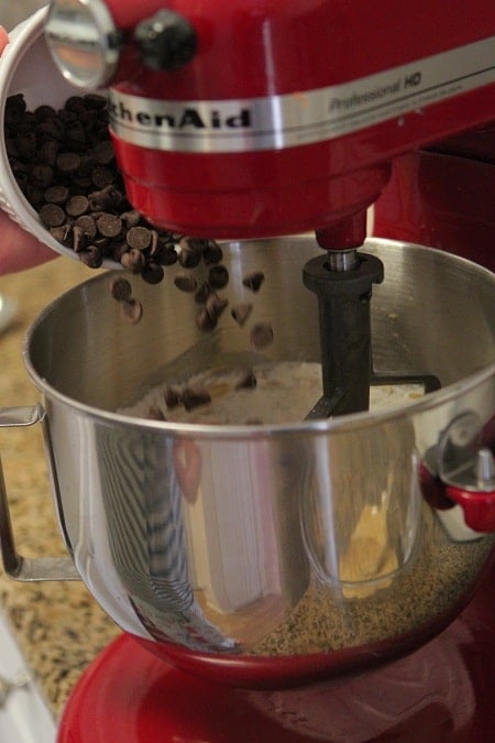 Image of Chocolate Chips Being Added to Oatmeal Cookie Batter