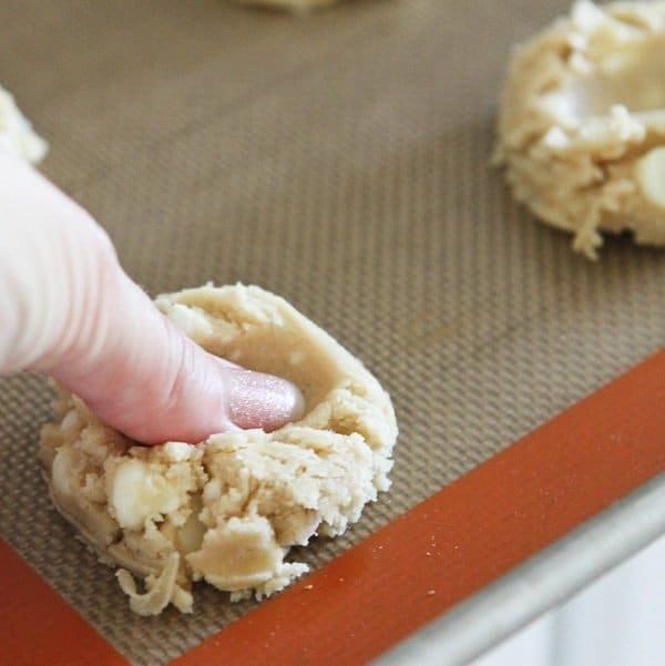 Image of a Thumb Imprinting White Chocolate Chip Cookie Dough 