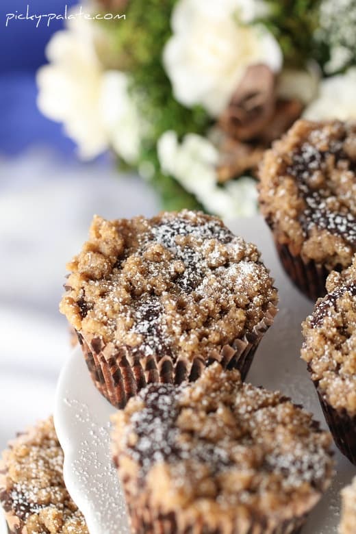 Chocolate cupcakes with a crumb topping on a plate.