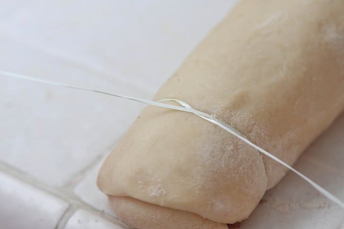 slicing dough with dental floss