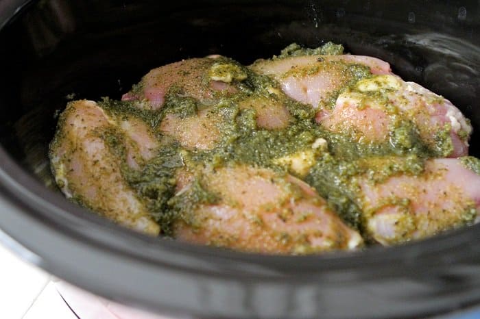 pesto spread over chicken thighs in crock pot