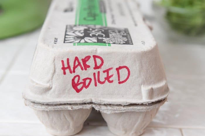 An egg carton with the words "hard boiled"