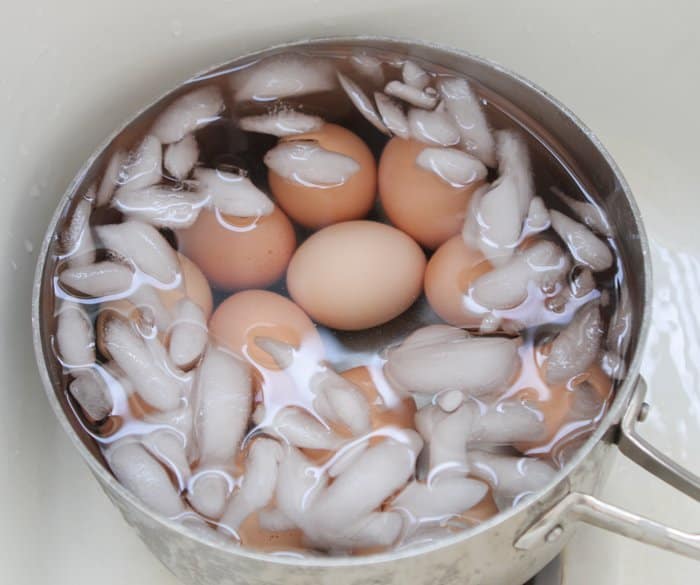 ice water in pan of boiled eggs