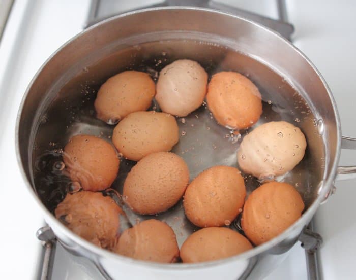 bringing water to boil with eggs in pan