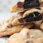 Oreo truffle surprise cookies stacked, with a cookie broken in half to show an Oreo truffle center.