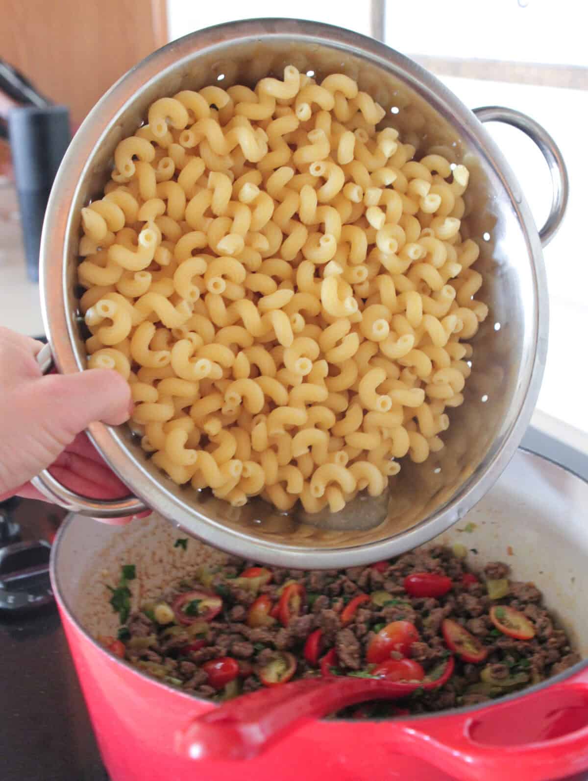 adding pasta to meat mixture