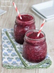 Two blueberry limeade slushies side-by-side with straws.