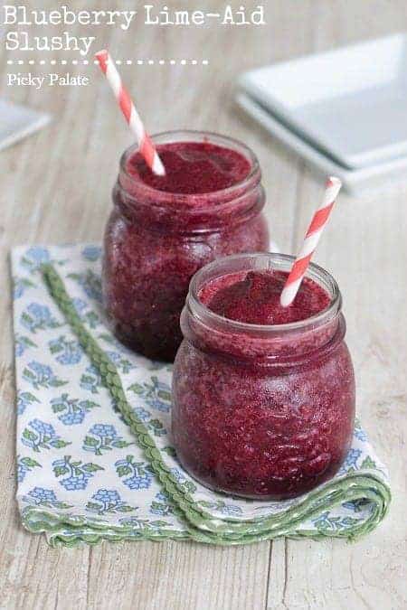 Two blueberry limeade slushies side-by-side with straws.