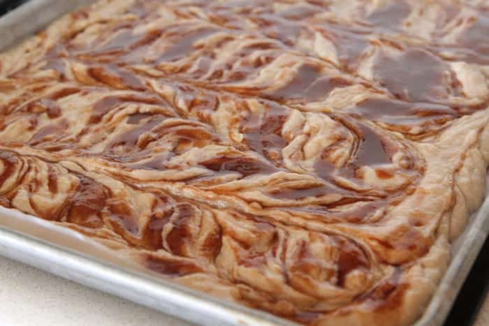 Cinnamon roll banana bread sheet cake in a baking pan.