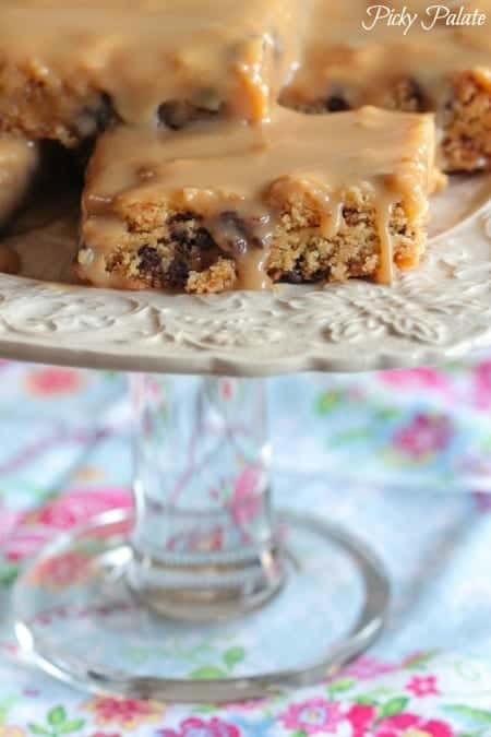 Biscoff chocolate chip cake bars on a cake stand.