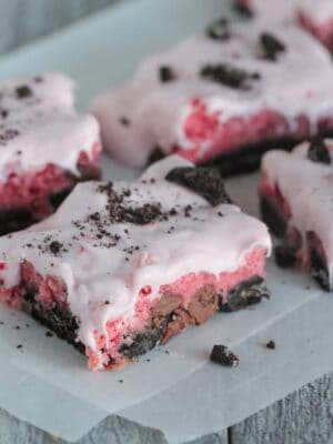 Oreo strawberry cake mix bars on parchment paper.
