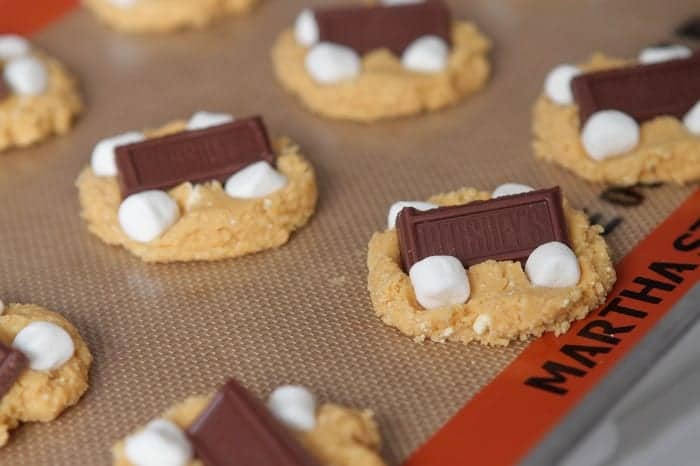 S'mores cake mix cookies on a silpat baking mat.