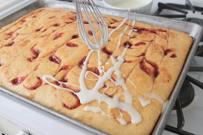 Peanut butter and jelly sheet cake in a baking pan.