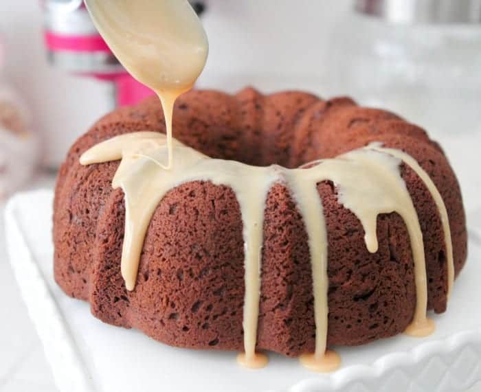 Chocolate peanut butter bundt cake drizzled with glaze.