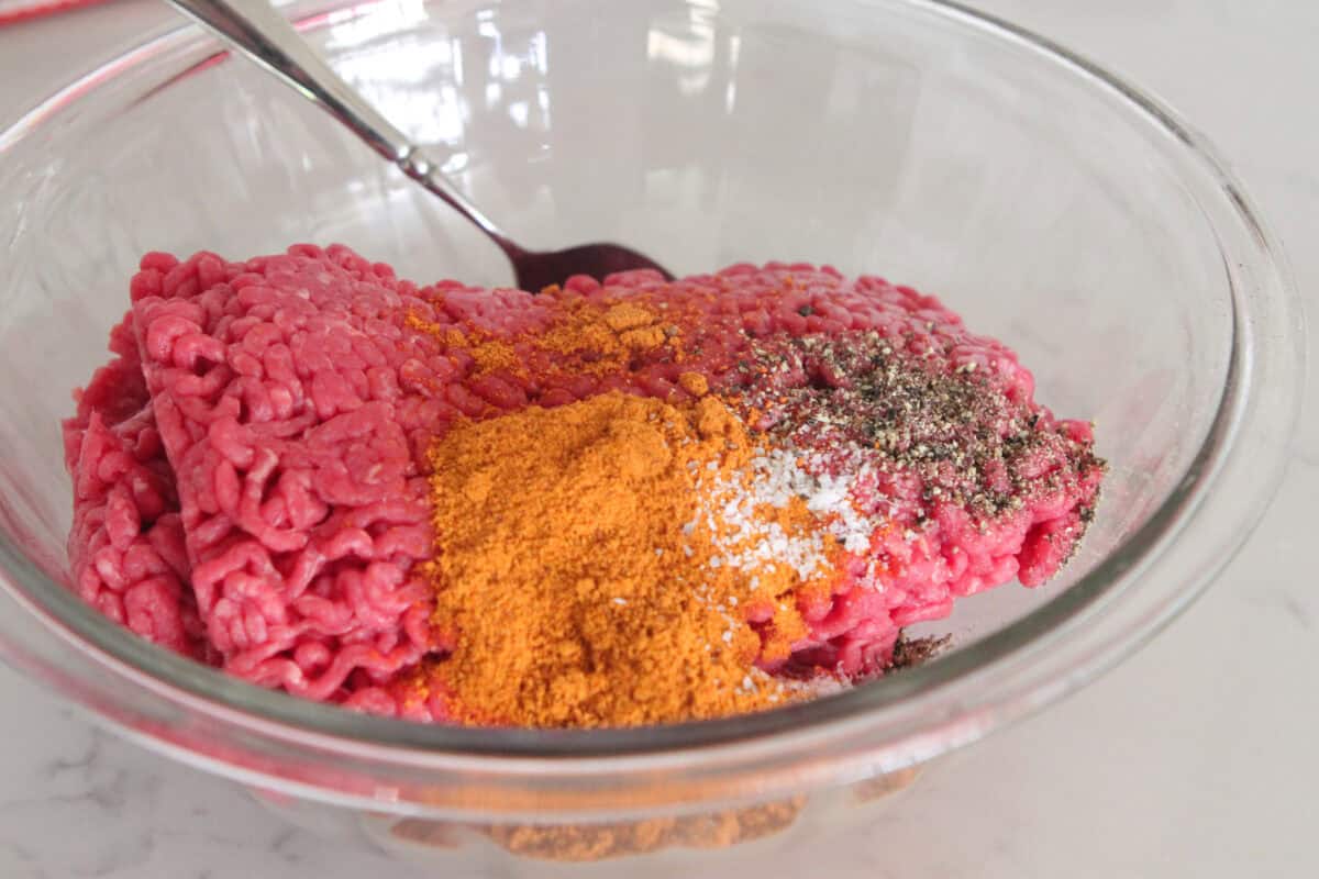 ground beef in mixing bowl with taco seasoning