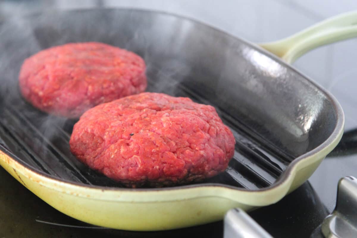 burgers grilling in grill pan
