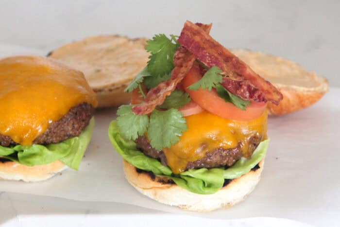 toppings added to burger on hamburger bun